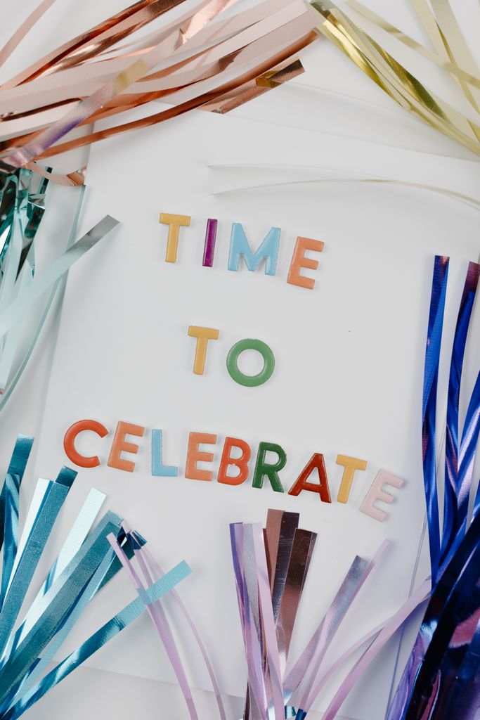 Colorful celebration with tinsel and decorative text, perfect for festival themes.